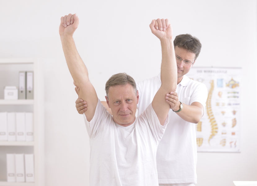 Physiotherapy: Senior man and physiotherapist at office